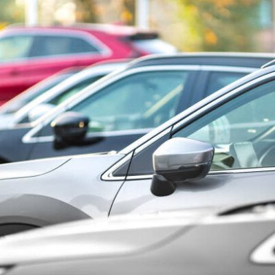 Side shot of a range of used modern vehicles, at a public car dealership